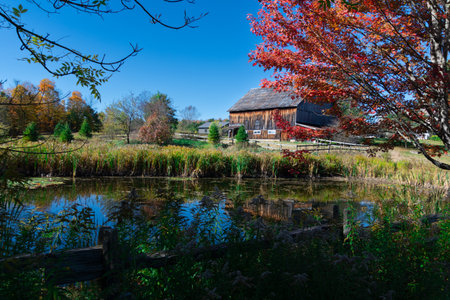 Beautiful barn on a farm in the Canadian countryside of Quebec in autumn colors