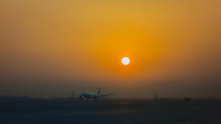 A plane landing at Dubai Airport, United Arab Emirates, at sunrise.の写真素材