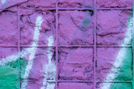 Old wall with rusty fittings painted in purple and greenの写真素材