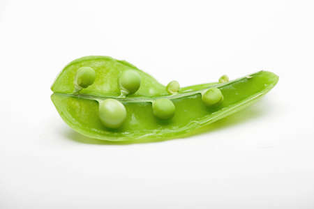 Peas in a pod on a white backgroundの写真素材