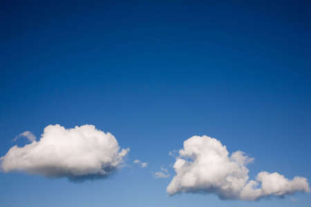 Two clouds on a blue skyの写真素材