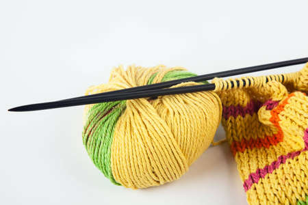 Knitting needles and yarn on white backgroundの写真素材