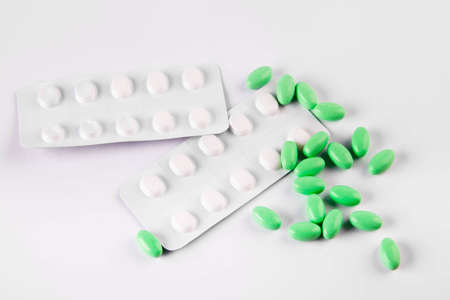Green pills on white backgroundの写真素材