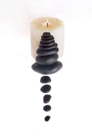 Candle and healing stones against white