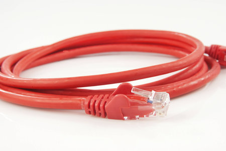 Red ethernet cable isolated against white