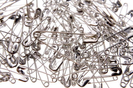 Safety pins over white
