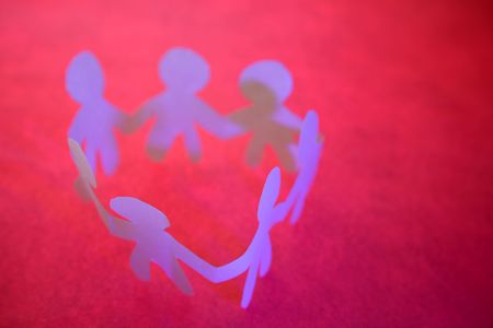 Paper-chain people in a circle holding handsの写真素材