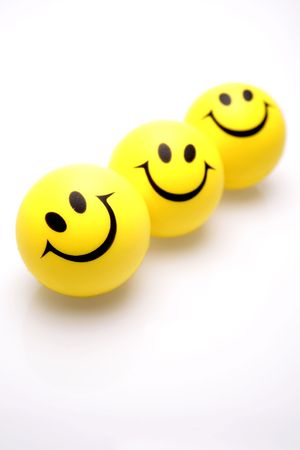 Three smiley faces over whiteの写真素材