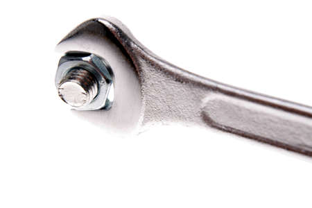 Spanner and nut over whiteの写真素材