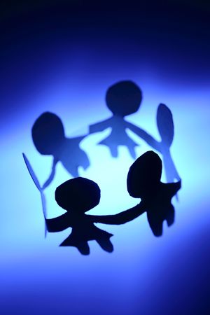 Paper-chain people in a circle holding handsの写真素材