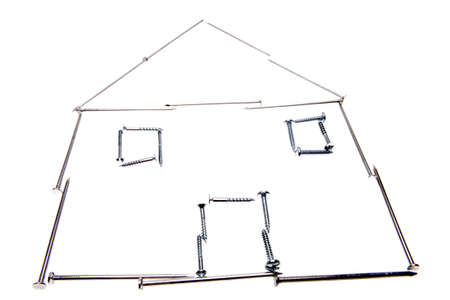 House made of nails and screws over whiteの写真素材