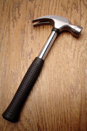 Hammer on wooden panelの写真素材