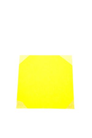 Piece of yellow paper on white