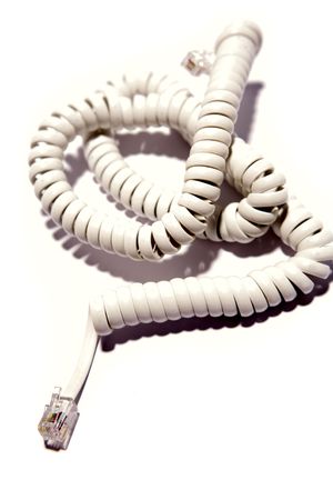 Curly telephone cord over whiteの写真素材