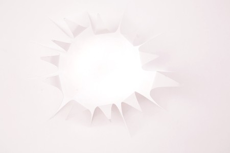 Hole in white paper の写真素材