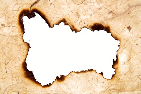 Hole burnt in brown paperの写真素材