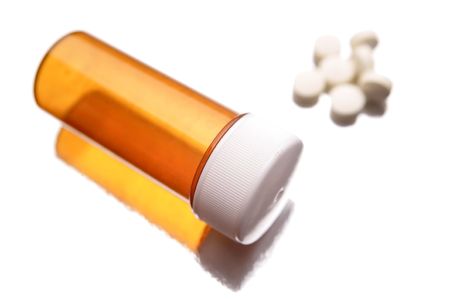 Empty pill container and pills on white backgroundの写真素材