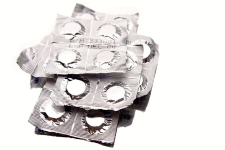 Pills in foil packs isolated on white backgroundの写真素材