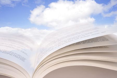 Open book in blue skyの写真素材