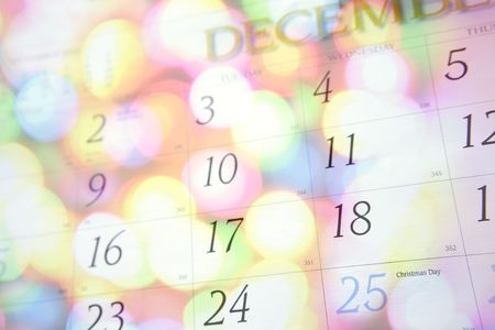December calendar blending with bright Christmas lights. の写真素材