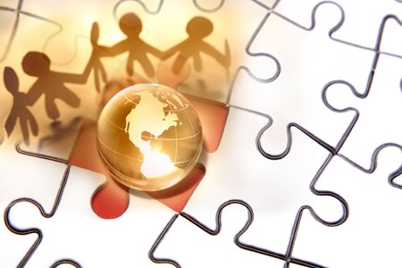 Team working together around globe on puzzle.の写真素材