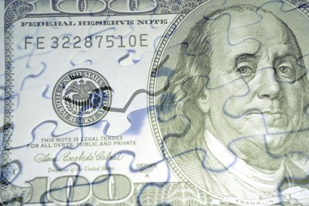 Hundred dollar American banknote and jigsaw puzzle composite.の写真素材