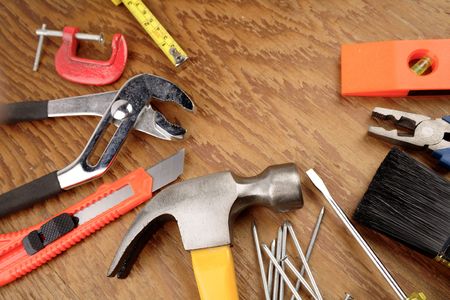 Assorted tools on wooden panel   