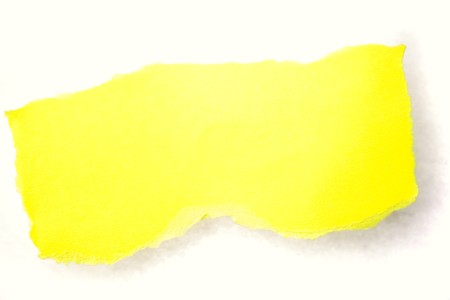 Piece of ripped yellow paper on plain backgroundの写真素材