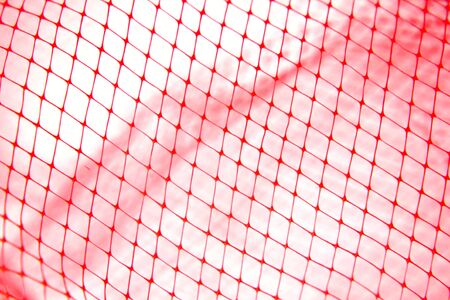 Close-up of red tone fishing netting の写真素材