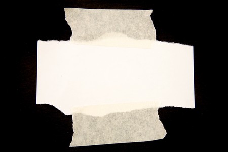 Note paper taped to black background の写真素材