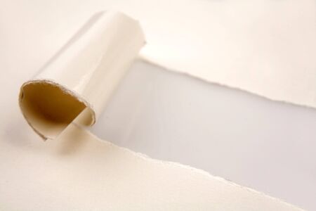 Hole ripped in white paperの写真素材