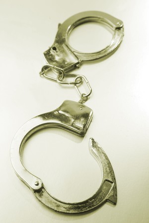 Set of handcuffs on plain background