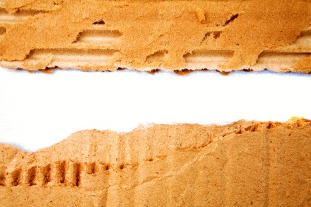 Hole ripped in corrugated cardboard   の写真素材