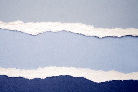 Ripped  paper on blue background の写真素材
