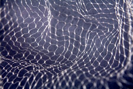Close-up of netting on blue background