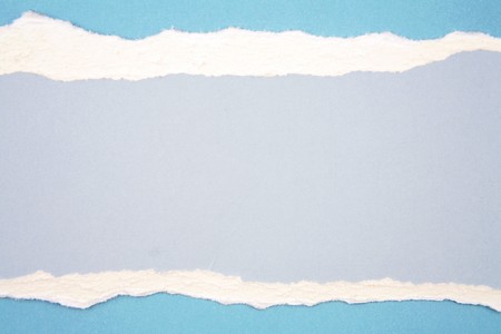 Ripped paper on blue background の写真素材