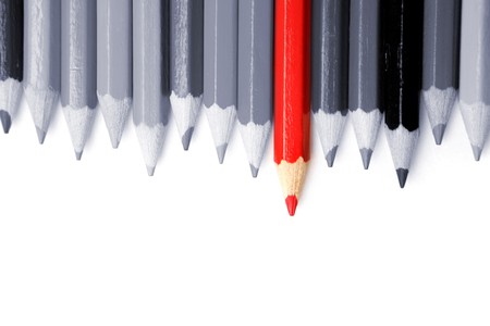 One red pencil standing out from dull pencilsの写真素材