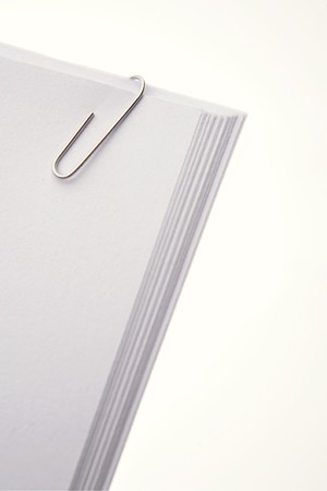Paper clip holding papers together  の写真素材