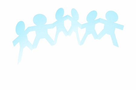 Group of people holding hands on plain background