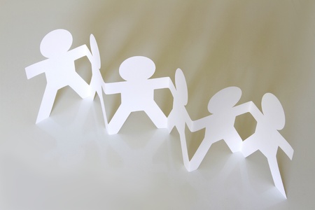 Group of paper chain people holding handsの写真素材