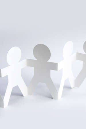 Paper doll people holding hands. Copy spaceの写真素材