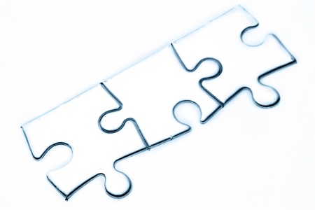 Three jigsaw puzzle pieces on plain backgroundの写真素材