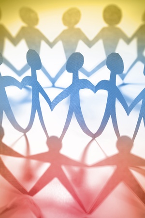 Paper doll people holding handsの写真素材