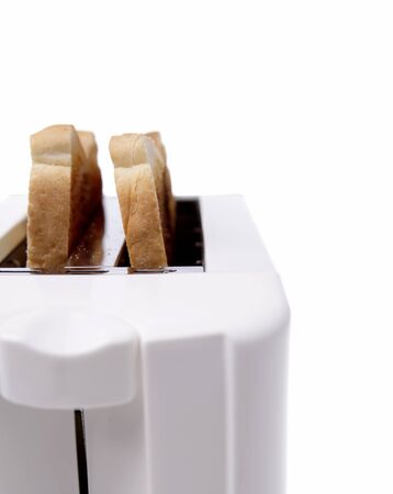 Toast in toaster on plain backgroundの写真素材