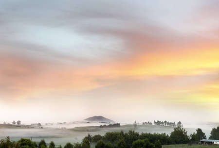 Beautiful sunrise over foggy farmlandのeditorial素材