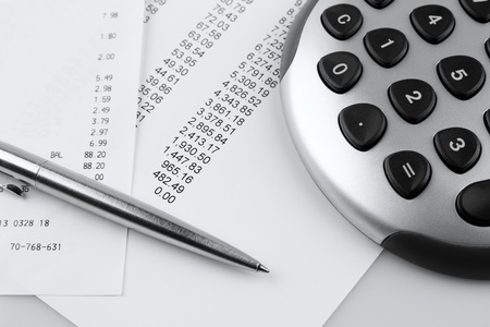 Closeup of financial figures, pen and calculatorの写真素材