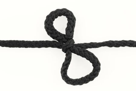 Knot tied in rope on whiteの写真素材