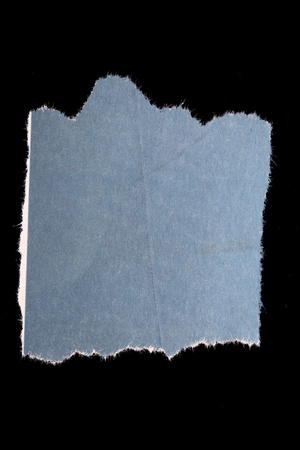 Torn piece of paper on black background