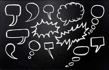 Speech bubbles drawn in chalk on blackboardの写真素材