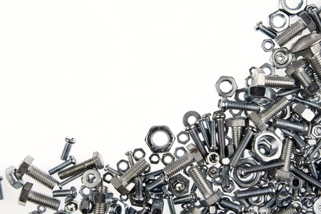 Chrome nuts and bolts closeup on plain backgroundの写真素材